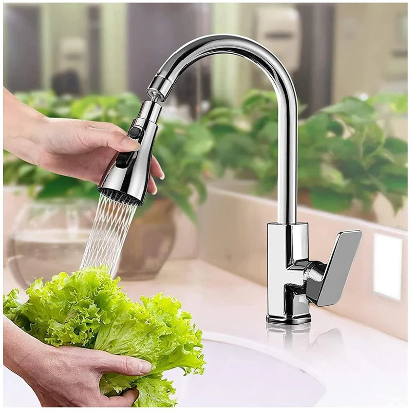 Chrome kitchen faucet with water flowing onto green lettuce in a kitchen setting.