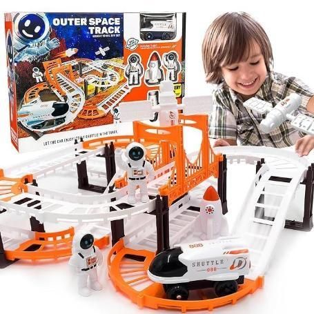 Child playing with an outer space track set and packaging