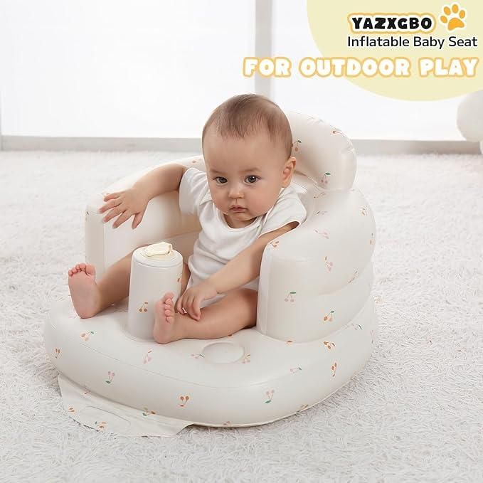 Baby sitting in an inflatable baby seat with 'YAZXCBO' branding on a light background