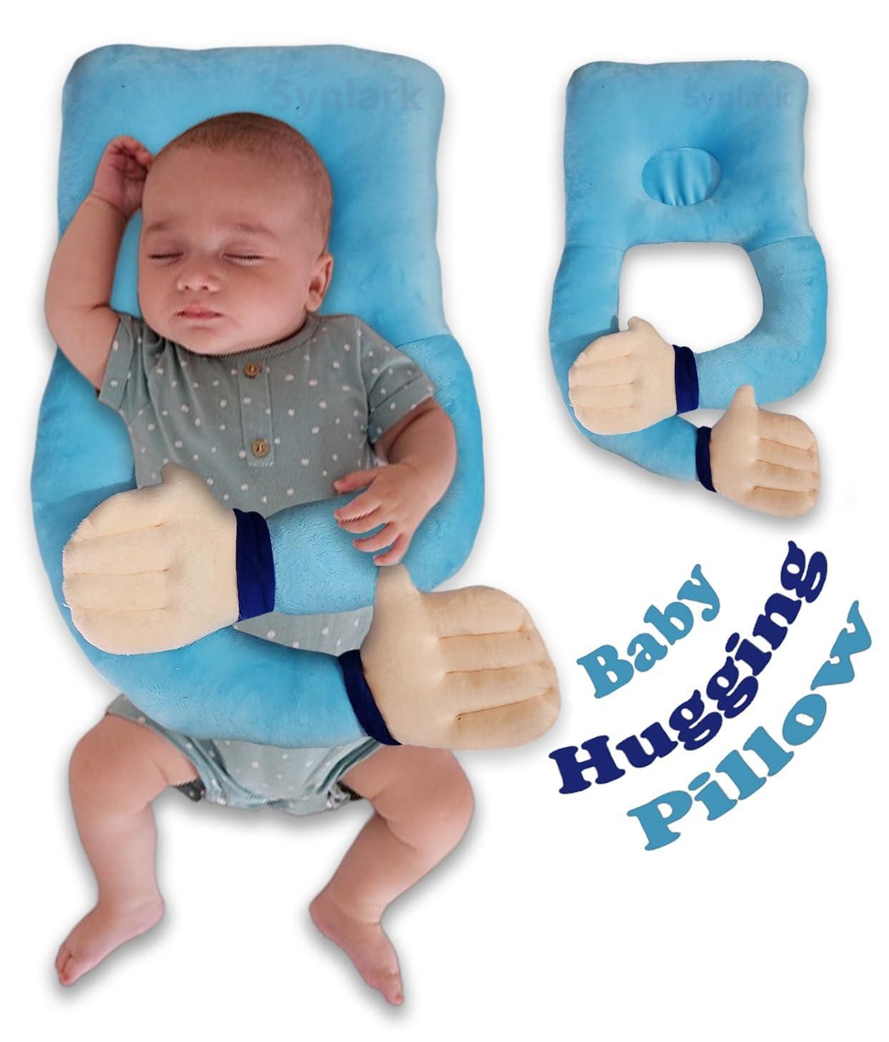 Baby sleeping on a blue baby hugging pillow with a close-up of the pillow on the side.
